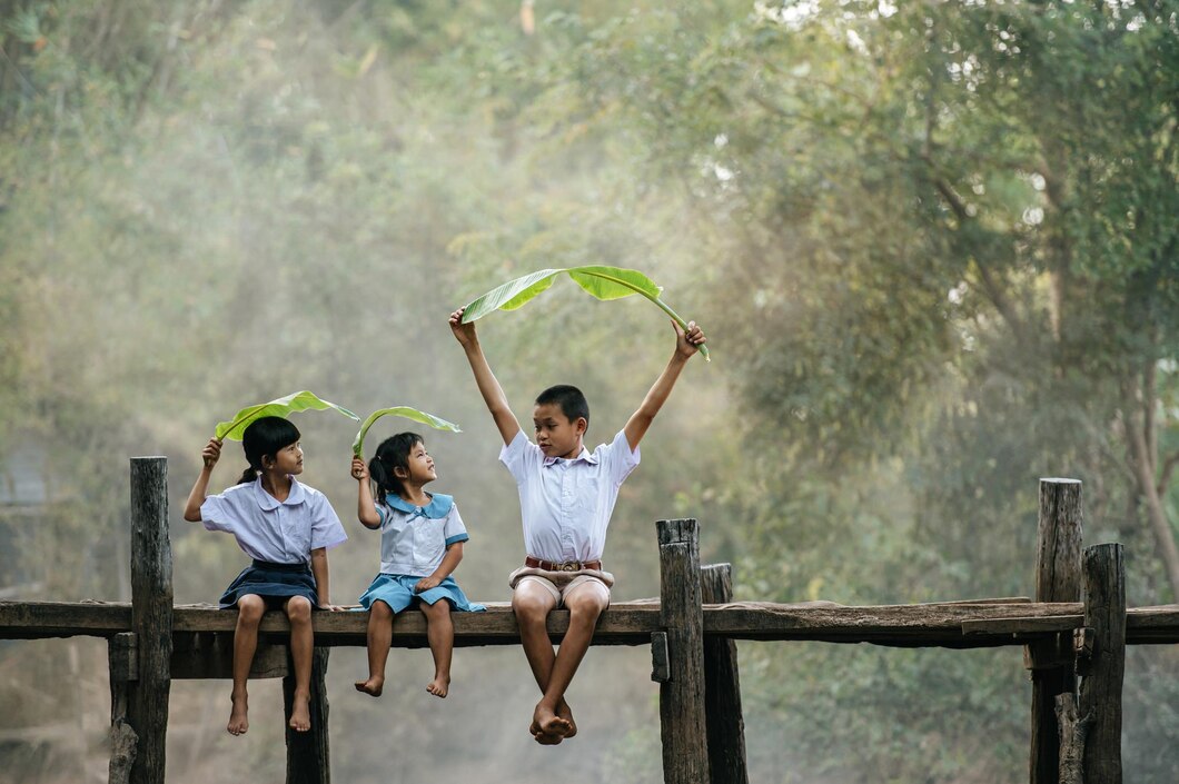 asian-boy-little-girls-sitting-wooden-bridge-joyful-playing-with-banana-leaves-head-smile-laughting-with-funny-together-copy-space-rural-scene-style-concept_1150-55885